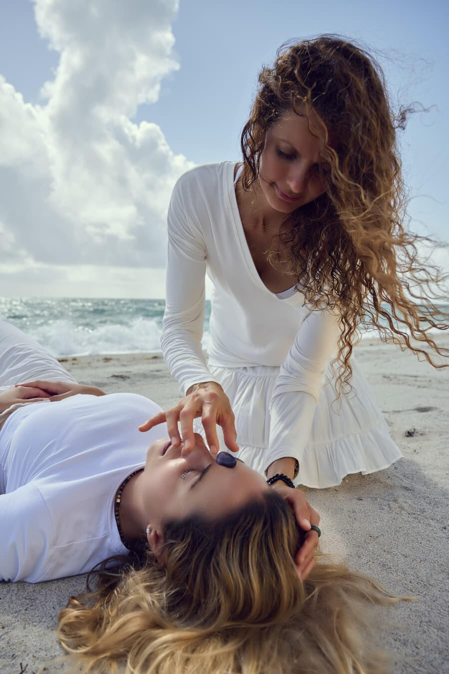 Breath therapy session with a crystal on the beach in Miami